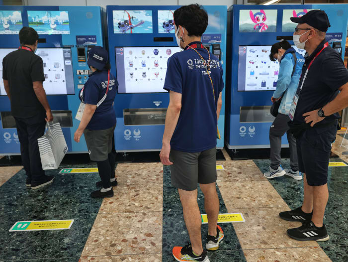 People wander outside of Tokyo Olympics vending machine